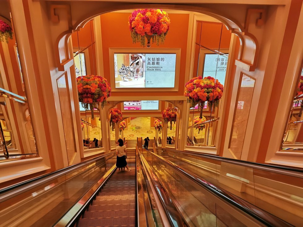 Friske blomsteropsætninger i evighedselevatoren mod hotellobbyen i Wynn Hotel - Turen går til: Macao